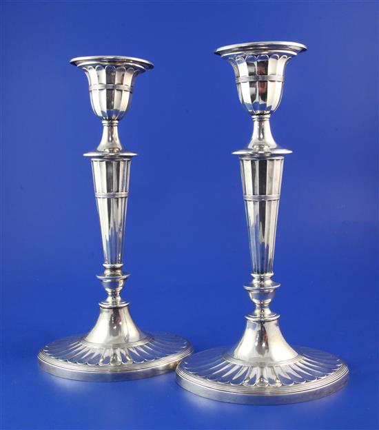 A pair of late Victorian silver oval candlesticks, weighted.